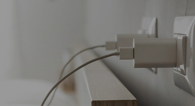 two outlets with phone chargers plugged in 