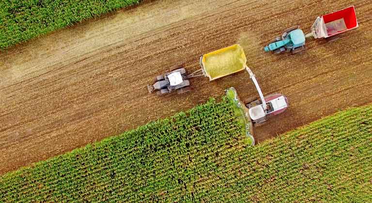 Aerial photo of farm equipment in a corn field